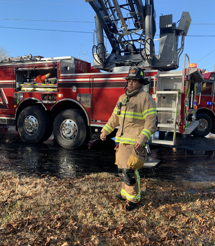 Fire man next to a fire truck